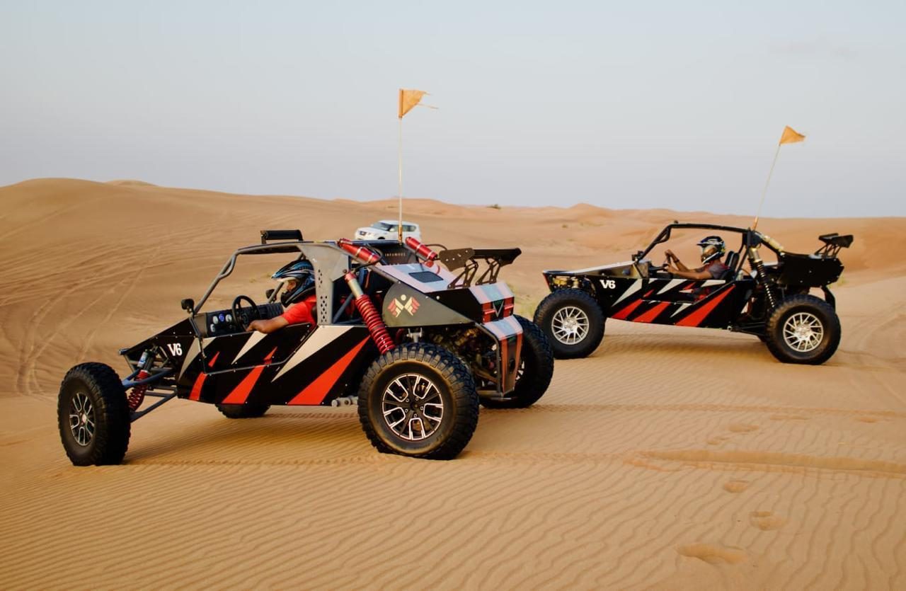 Two custom desert buggies side by side